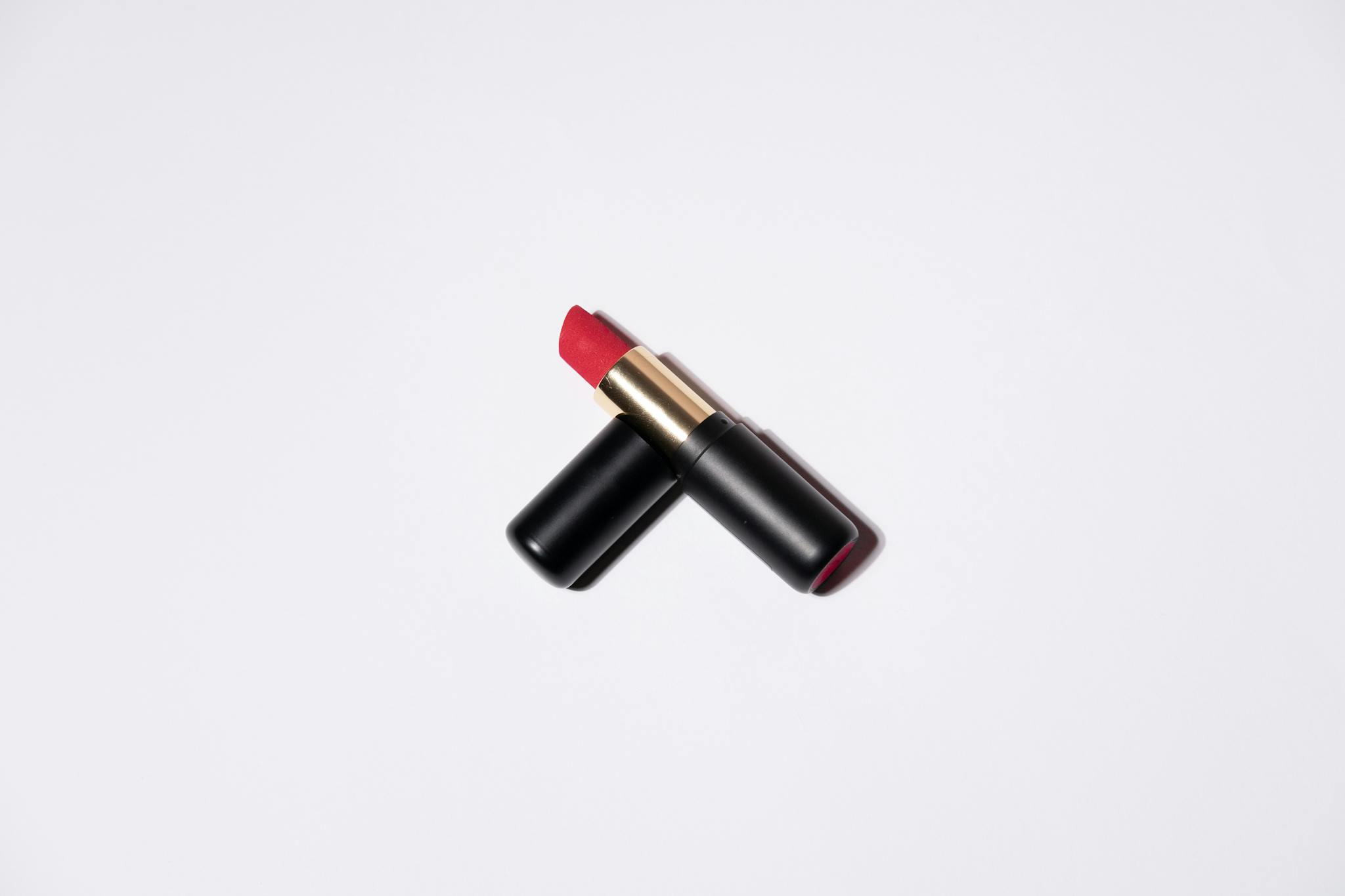 High-quality image of a vibrant red lipstick on a white background, perfect for beauty and cosmetic themes.
