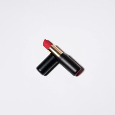 High-quality image of a vibrant red lipstick on a white background, perfect for beauty and cosmetic themes.