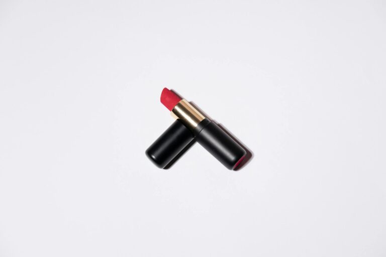 High-quality image of a vibrant red lipstick on a white background, perfect for beauty and cosmetic themes.